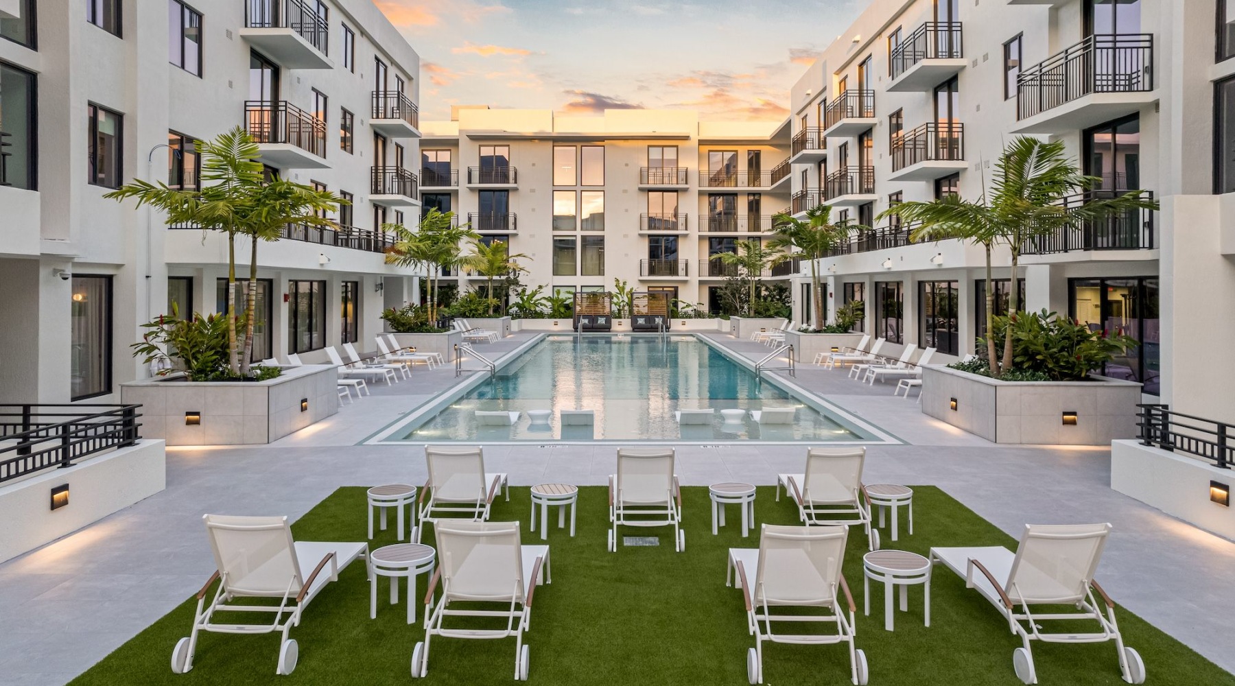 Relax and unwind poolside view of a pool in a courtyard with chairs