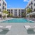 pool in a courtyard with lounge chairs