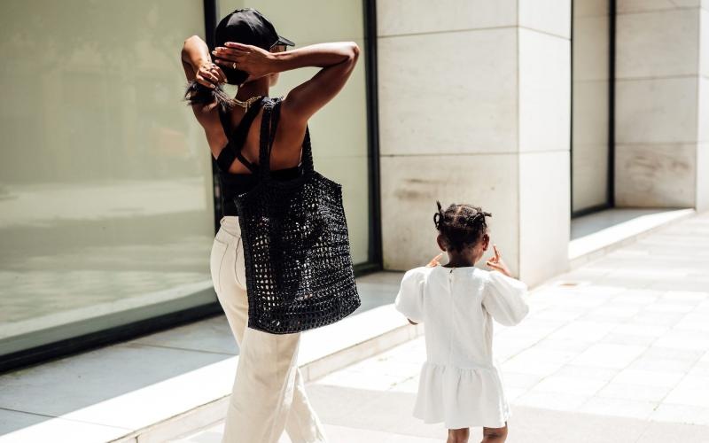 a woman walking with her child