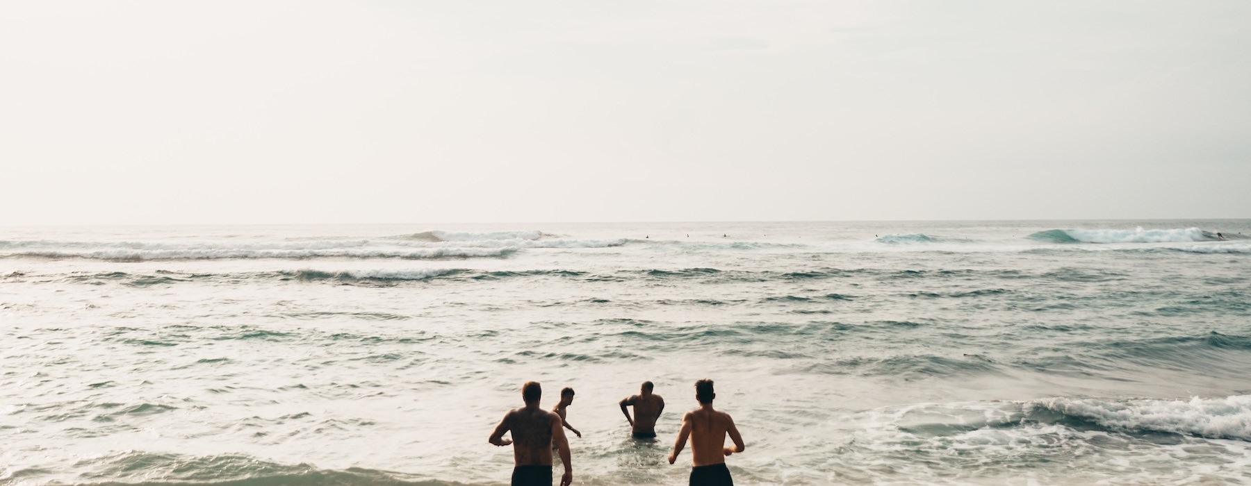 a group of people playing at the beach
